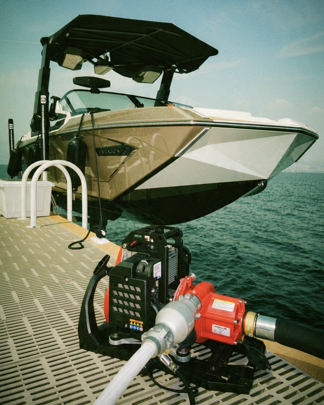 High-volume water pump set up on a lakeside dock beside a boat to supply a wildfire sprinkler system